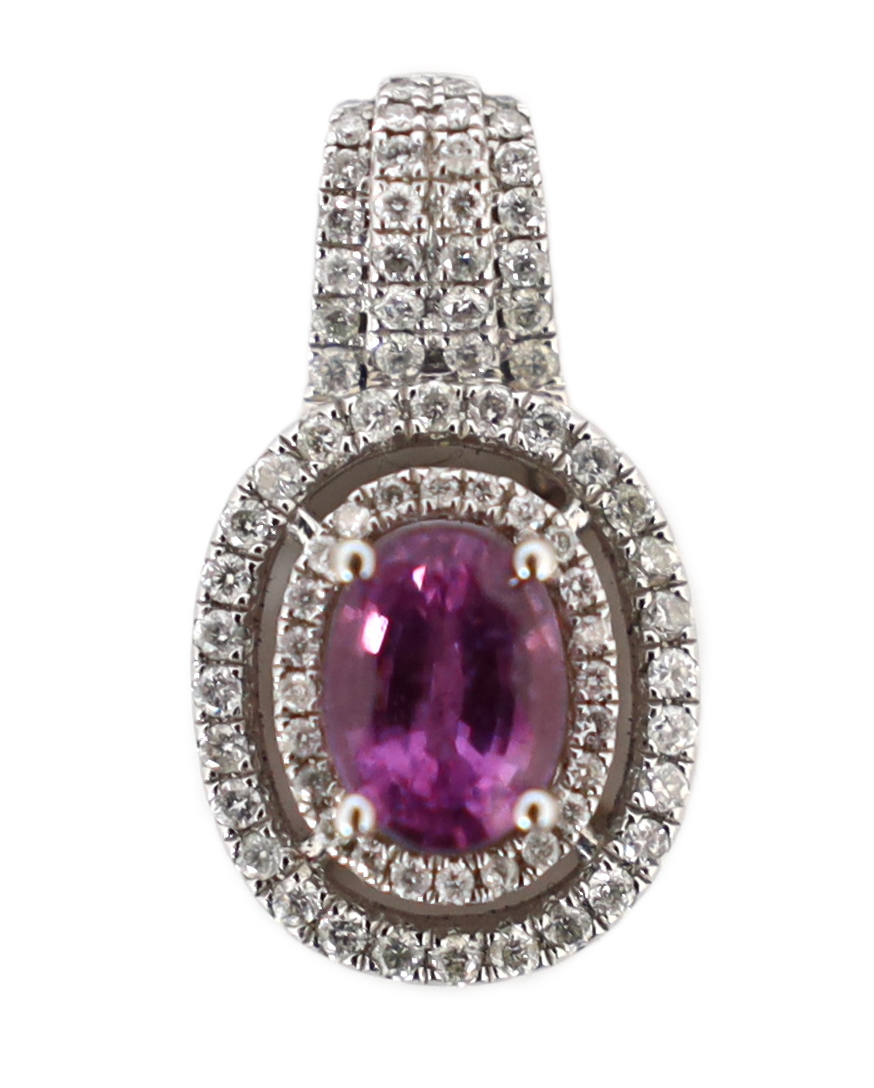 A modern 14ct white gold, pink sapphire and diamond set oval cluster pendant